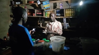 A family uses solar lights to run their shop at night. Before they had to close by 6pm