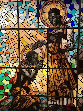 St Kizito being baptised by St Charles Lwanga at Munyonyo. Munyonyo Martyrs Shrine,  © Wikimedia