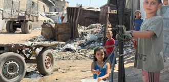 Children fill buckets with water in Gaza city. Photo by OCHA/Olga Cherevko