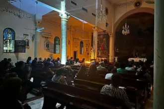 Mass by candlelight at Church of the Holy Family when there is no electricity. Image: ACN