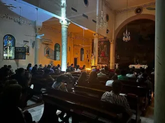 Mass by candlelight at Church of the Holy Family when there is no electricity. Image: ACN
