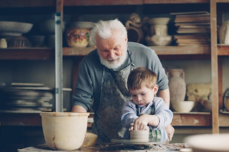 Grandad teaches his grandson pottery. Photo by Vitaly Gariev on Unsplash