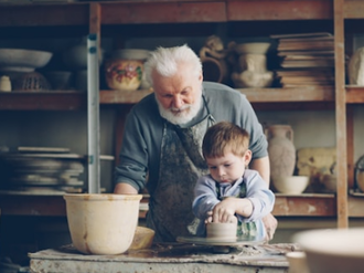 Grandad teaches his grandson pottery. Photo by Vitaly Gariev on Unsplash
