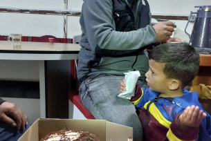 Awdah with his son and the cake Maureen left for him - on what was to be his last birthday.