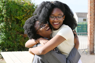 Winifred Otubo who achieved ten 9s, celebrates with her mother Patience Otubo