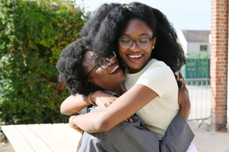 Winifred Otubo who achieved ten 9s, celebrates with her mother Patience Otubo