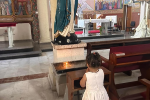 Child prays at Holy Family Church. Image: Latin Patriarchate Jerusalem
