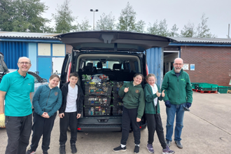 Generous  St Alban's pupils delivering their donations to the Wirral Foodbank