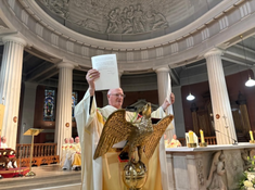 During Mass Archbishop Farrell holds up the Papal decree at St Mary's Cathedral. Image: CCO