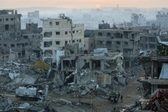 Palestinians walk past the rubble of destroyed buildings in Gaza City, Source: Vatican News