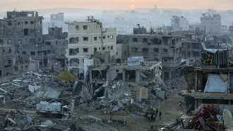 Palestinians walk past the rubble of destroyed buildings in Gaza City, Source: Vatican News