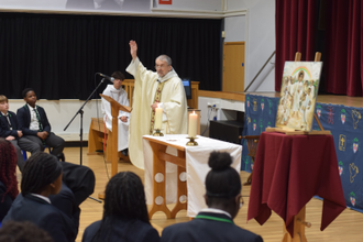 Fr Keith Stoakes blesses pupils at the Mass