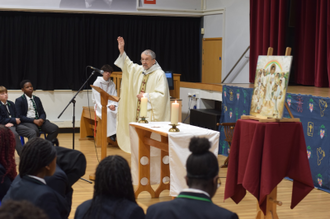Fr Keith Stoakes blesses pupils at the Mass