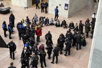 Police handcuff Marie Dennis, in red coat, in Senate Hart Building, Washington DC