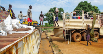 Aid being loaded onto Nile River barge in South Sudan for delivery to remote communities. ©WFP/Peter Louis