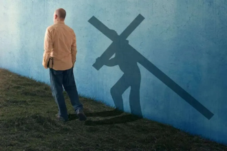 A man walking with his shadow carrying the cross.  Digitally mastered photo by Kevin Carden,  2014   ©Kevin Carden / GoodSalt