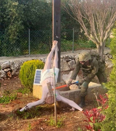 IDF soldier hitting crucifix with hammer (from social media by Younis Tirawi)