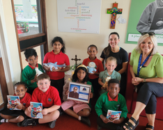 Miss Chapman, Mrs Hart and the children with their CAFOD Animals and copies of the booklet 'God's Microphones' which they wrote.