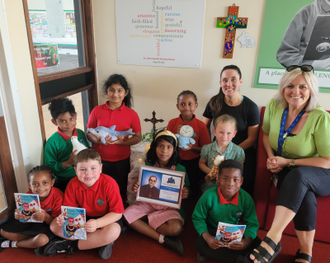 Miss Chapman, Mrs Hart and the children with their CAFOD Animals and copies of the booklet 'God's Microphones' which they wrote.