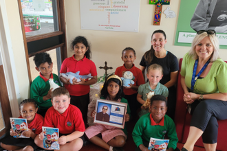 Miss Chapman, Mrs Hart and the children with their CAFOD Animals and copies of the booklet 'God's Microphones' which they wrote.