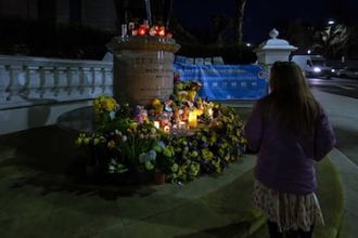 Prayers, floral tributes and candles at statue of Ukrainian Saint Volodymyr, Holland Park