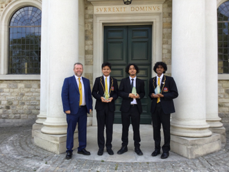 Headteacher Chris McCormack with award winners: Abdul Majid, Reuben, and Luginton