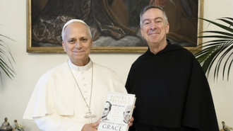 Pope Leo XIV poses for a photo with his book and Fr Joseph Farrell, Prior General of the Order of Saint Augustine.  Image: Vatican Media