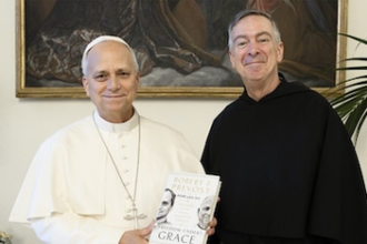 Pope Leo XIV poses for a photo with his book and Fr Joseph Farrell, Prior General of the Order of Saint Augustine. Image: Vatican Media
