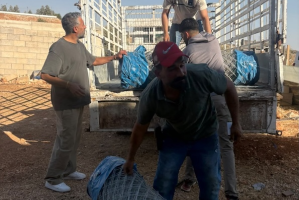 Adam Rabia, head of field operations, delivering fencing and flashlights to Abu Hamdan in Burqa.