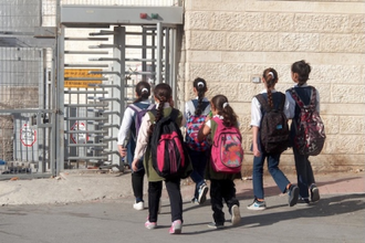 Palestinian children pass Shufat checkpoint on their way to school. Photo: WCC/E. Mutschler