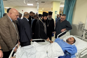Delegation at bedside of man injured in church shooting © Greek Orthodox Archdiocese of Jordan